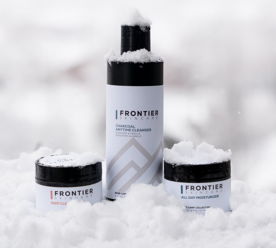 Three Frontier skincare products in snow.